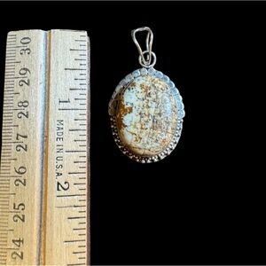 Sterling silver pendant.Pre-Owned beautiful brown and beige color stone.no chain